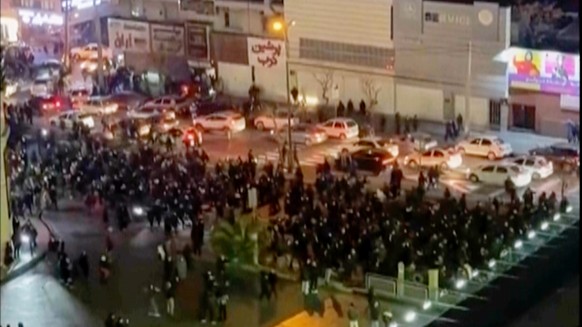 In this frame grab from video taken by an individual not employed by The Associated Press and obtained by the AP outside Iran shows people blocking an intersection during a protest in Tehran, Iran, Th ...