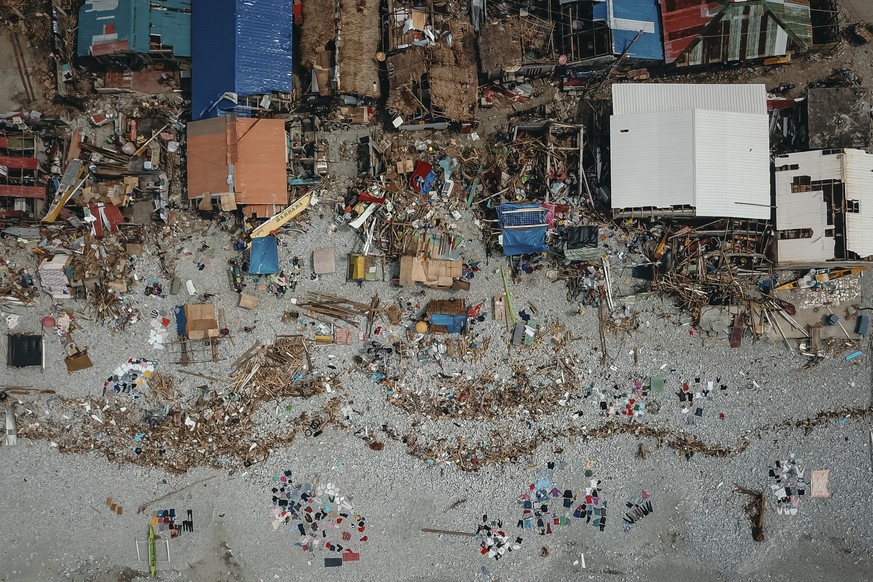 In this photo provided by Greenpeace, damaged homes due to Typhoon Rai along a coastal village in Surigao City, southern Philippines Tuesday, Dec. 21, 2021. The governor of a central Philippine provin ...