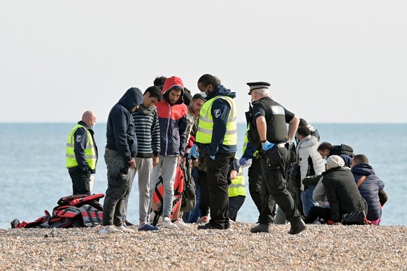 epa10199379 Migrants who were rescued in the English Channel arrive on a beach in Dungeness, Britain, 22 September 2022. According to the British Ministry of Defence, more than 30,000 people crossed t ...