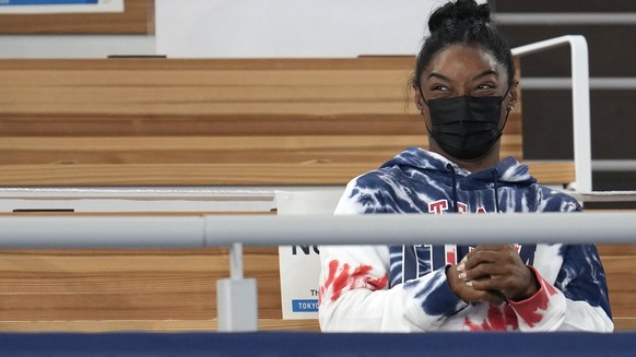 Simone Biles, of the United States, and teammate Mykayla Skinner watch the artistic gymnastics men&#039;s all-around final at the 2020 Summer Olympics, Wednesday, July 28, 2021, in Tokyo. (AP Photo/Na ...