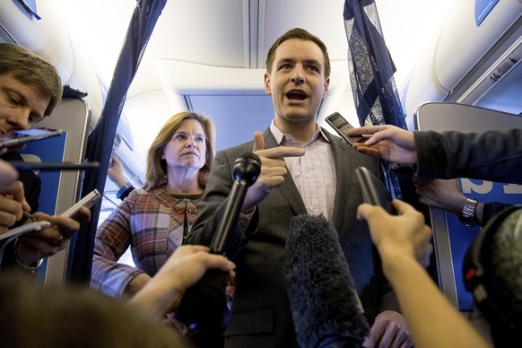 FILE - In this Friday, Oct. 28, 2016 file photo, Robby Mook, center, accompanied by Director of Communications Jennifer Palmieri, speaks to members of the media aboard Democratic presidential candidat ...