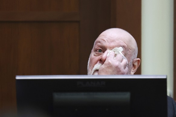 Isaac Baruch wipes tears as he testifies in the courtroom at the Fairfax County Circuit Courthouse in Fairfax, Va., Wednesday, April 13, 2022. Actor Johnny Depp sued his ex-wife Amber Heard for libel  ...