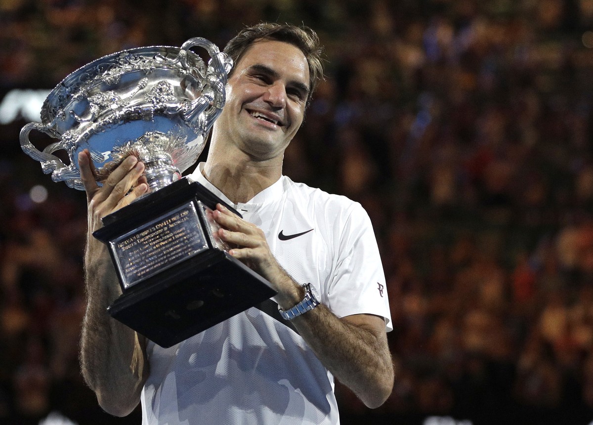 FILE - In this Jan. 28, 2018, file photo, Switzerland's Roger Federer holds his trophy after defeating Croatia's Marin Cilic during the men's singles final at the Australian Open tennis ...
