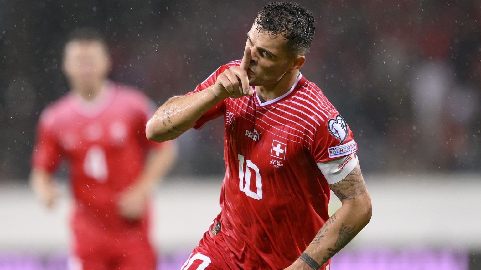 Switzerland&#039;s midfielder Granit Xhaka celebrates his goal putting your finger in front of your mouth after spring the 2:0, during the UEFA Euro 2024 qualifying group I soccer match between Switze ...