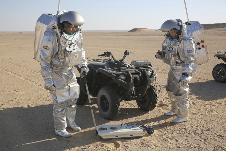 In this Feb. 7, 2018, photo, two scientists test space suits and a geo-radar for use in a future Mars mission in the Dhofar desert of southern Oman. The desolate desert in southern Oman resembles Mars ...