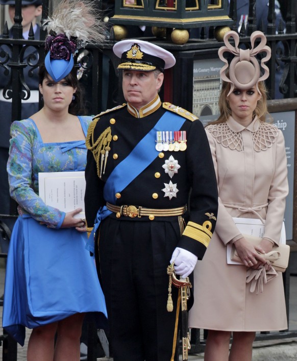 FILE - In this April, 29, 2011 file photo, Britain&#039;s Prince Andrew, center, and his daughters Britain&#039;s Princess Eugenie, left, and Britain&#039;s Princess Beatrice leave Westminster Abbey a ...