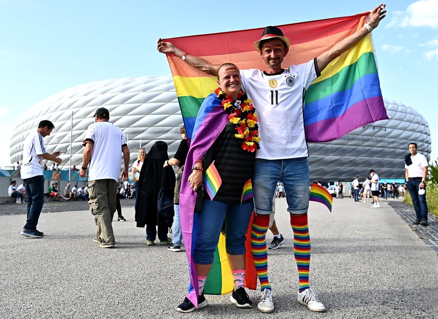 epa09295740 Fans of Germany pose with rainbow flags as they arrive at Arena Munich prior to the UEFA EURO 2020 group F preliminary round soccer match between Germany and Hungary in Munich, Germany, 23 ...