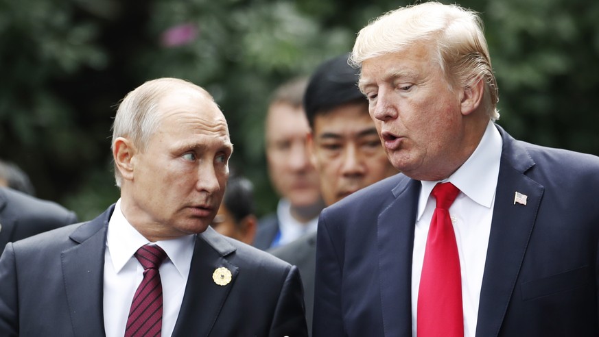 epa06847023 (FILE) - US President Donald J. Trump (R) and Russia&#039;s President Vladimir Putin talk during a family photo session at the Asia-Pacific Economic Cooperation (APEC) Economic Leaders&#03 ...