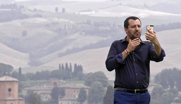 epa06860747 Interior Minister Matteo Salvini poses for a selfie during a visit to an estate which was permanently confiscated in 2007 from the mafia, in Suvignano (Siena), Italy, 03 July 2018. The est ...