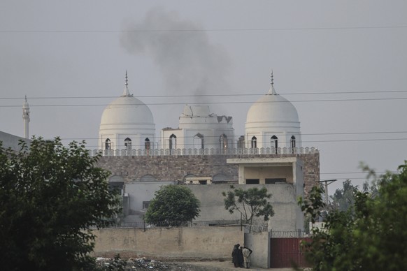 Local residents stand outside a mosque of an Islamic seminary partially damaged by a suspected Indian missile attack, outskirts of Bahawalpur, Pakistan, Wednesday, May 7, 2025. (AP Photo/Asim Tanveer) ...