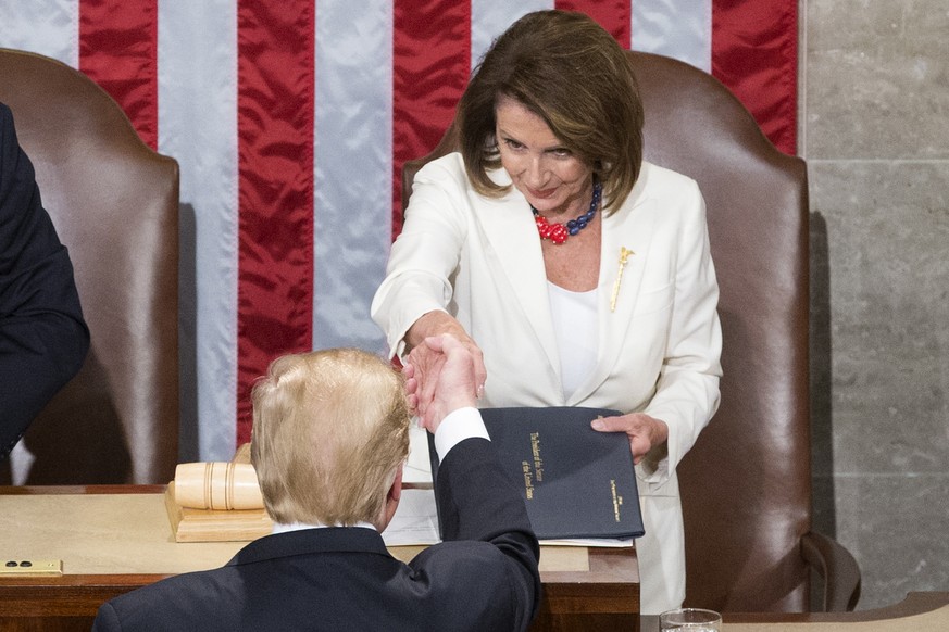 epa07346687 US President Donald J. Trump (Bottom) shakes hands with Speaker of the House Nancy Pelosi (Top) before delivering his second State of the Union address from the floor of the House of Repre ...