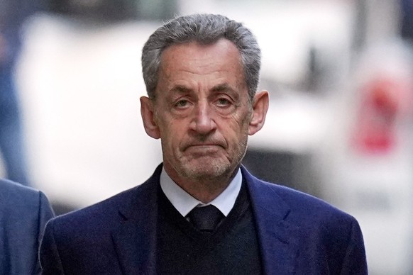 FILE - Former French President Nicolas Sarkozy leaves his home Tuesday, Oct. 21, 2025 in Paris as he heads to prison to serve time for a criminal conspiracy to finance his 2007 election campaign with  ...