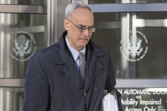 Manuel Burga leaves federal court in the Brooklyn borough of New York, Friday, Nov. 17, 2017. Burga, of Peru, is one of three former South American soccer officials on trial in a U.S. case highlightin ...