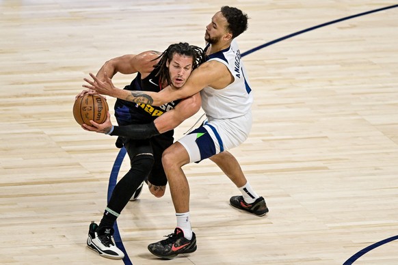 epa11323404 Denver Nuggets forward Aaron Gordon (L) is wrapped up defensively by by Minnesota Timberwolves forward Kyle Anderson in the first half of game two of the Western Conference semifinal serie ...