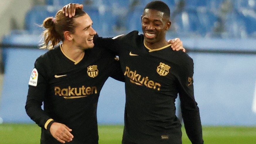 epa09088916 Barcelona&#039;s Ousmane Dembele celebrates with team mate with Antoine Griezmann (L) after scoring the 0-5 goal during the Spanish LaLiga soccer match between Real Sociedad and FC Barcelo ...