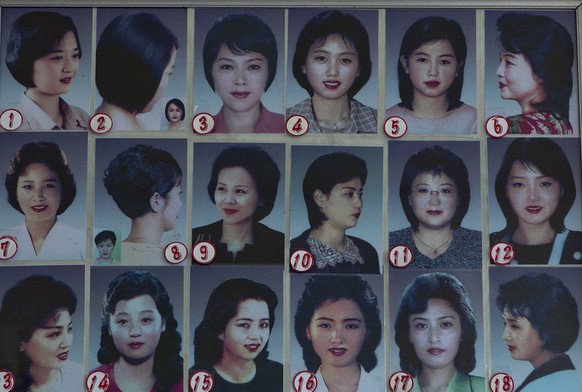 Photos showing example hair styles hang inside a hair salon in Pyongyang, North Korea on Wednesday, Feb. 20, 2013. (AP Photo/David Guttenfelder)