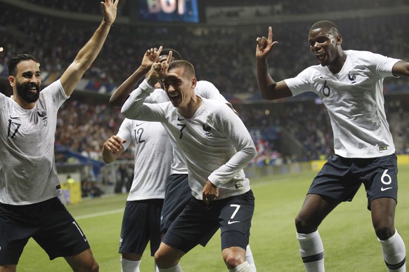 France's Antoine Griezmann, 2nd right, celebrates after scoring his side's 2nd goal with teammates : Paul Pogba, right, Corentin Tolisso and Edil Rami, left, during a friendly soccer match between Fra ...