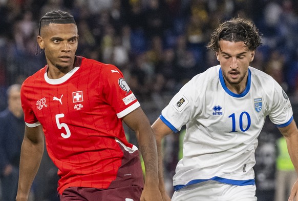 Switzerland&#039;s Manuel Akanji, left, plays the ball against Kosovo&#039;s Leon Avdullahu, during the FIFA 2026 World Cup Group B qualifying soccer match between Switzerland and Kosovo at the St. Ja ...