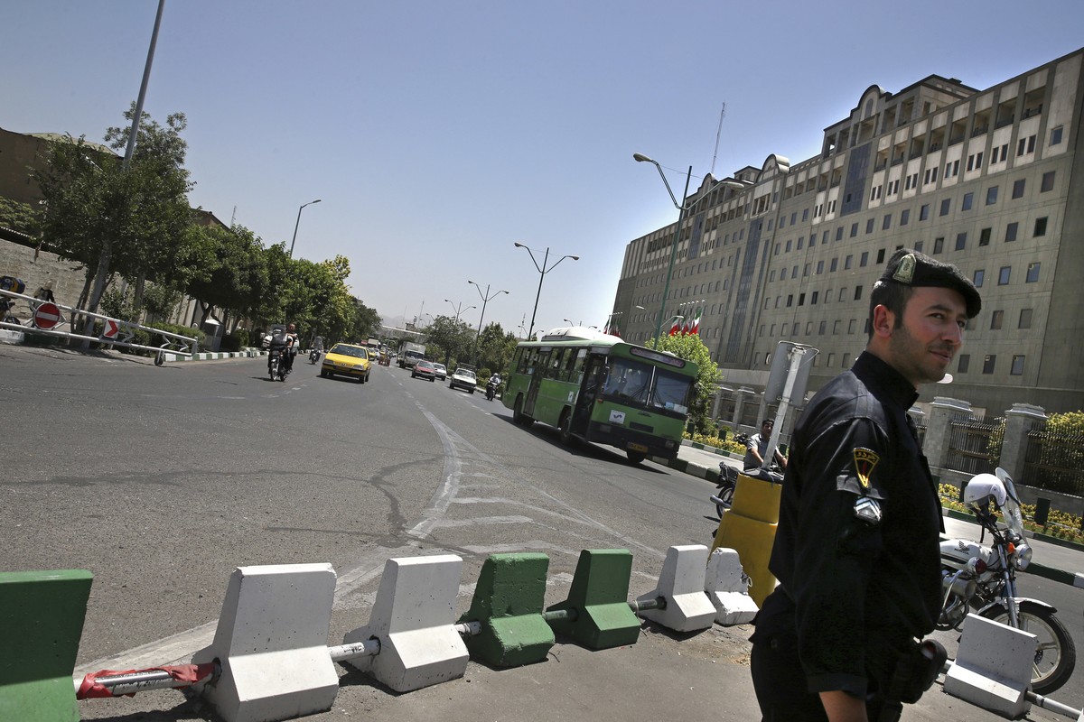 A police officer stands guard as vehicles drive in front of Iran's parliament building in Tehran, Iran, Thursday, May 8, 2017. Police increased their patrols in the streets and subway stations of ...