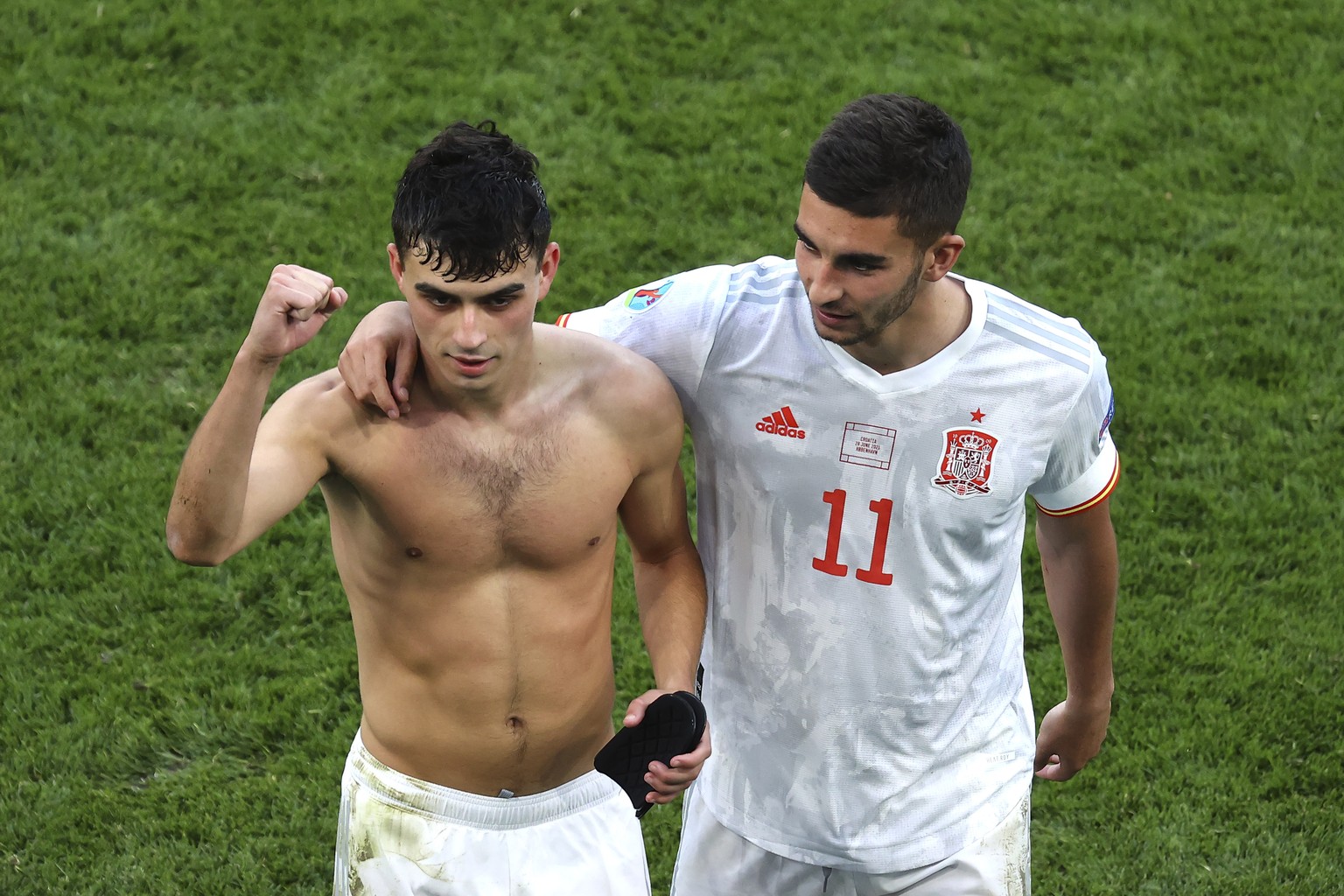 Spain's Ferran Torres, right, and Pedri celebrate a victory of their team after the end of the Euro 2020 soccer championship round of 16 match between Croatia and Spain, at Parken stadium in Copenhage ...