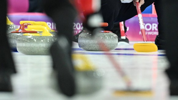 250117 -- TURIN, Jan. 17, 2025 -- Hou Fuqiang of China instructs his teammates to sweep during the curling men s round robin session match between China and Canada at the Torino 2025 FISU World Univer ...