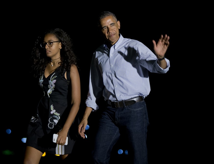 President Barack Obama, with his daughter Sasha Obama, waves upon arrival at the White House in Washington, Sunday, June 19, 2016, from a trip to California, where he visited the Yosemite National Par ...