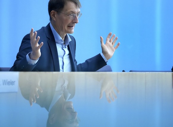 German Health Minister Karl Lauterbach gestures during a press conference on the current coronavirus pandemic in Berlin, Germany, Wednesday, Dec. 22, 2021. (AP Photo/Michael Sohn)