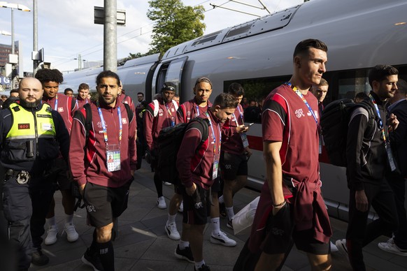 epa11410323 (L-R) Switzerland players Cedric Zesiger, Xherdan Shaqiri, Noah Okafor, Breel Embolo, Ricardo Rodriguez, Manuel Akanji, and teammates disembark a train surrounded by security personnel at  ...