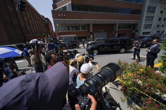 Reporters huddle as a vehicle, top right, leaves with President Joe Biden?s son Hunter Biden, after a court appearance, Wednesday, July 26, 2023, in Wilmington, Del. The plea deal in Hunter Biden?s cr ...