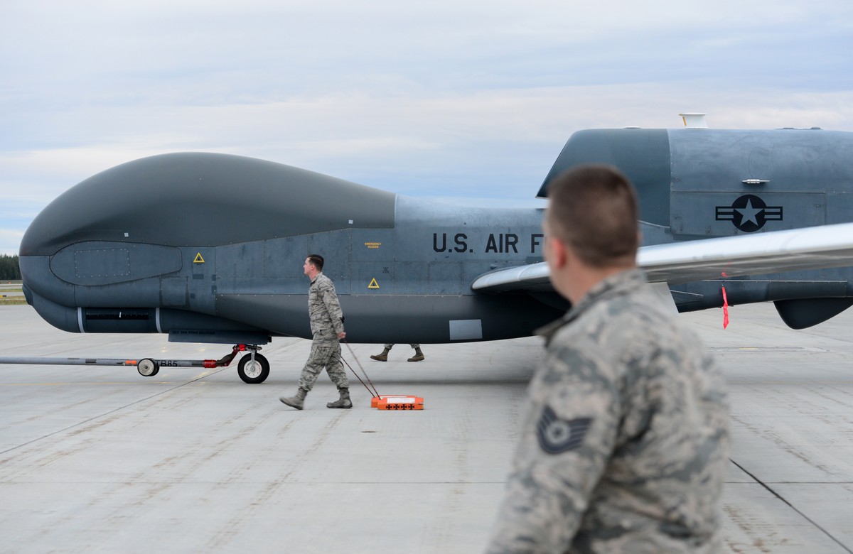 epa07659383 A handout photo made available by the US Defense Visual Information Distribution Service (DIVIDS) showing a team of 12th Aircraft Maintenance Unit Airmen walking beside an RQ-4 Global Hawk ...