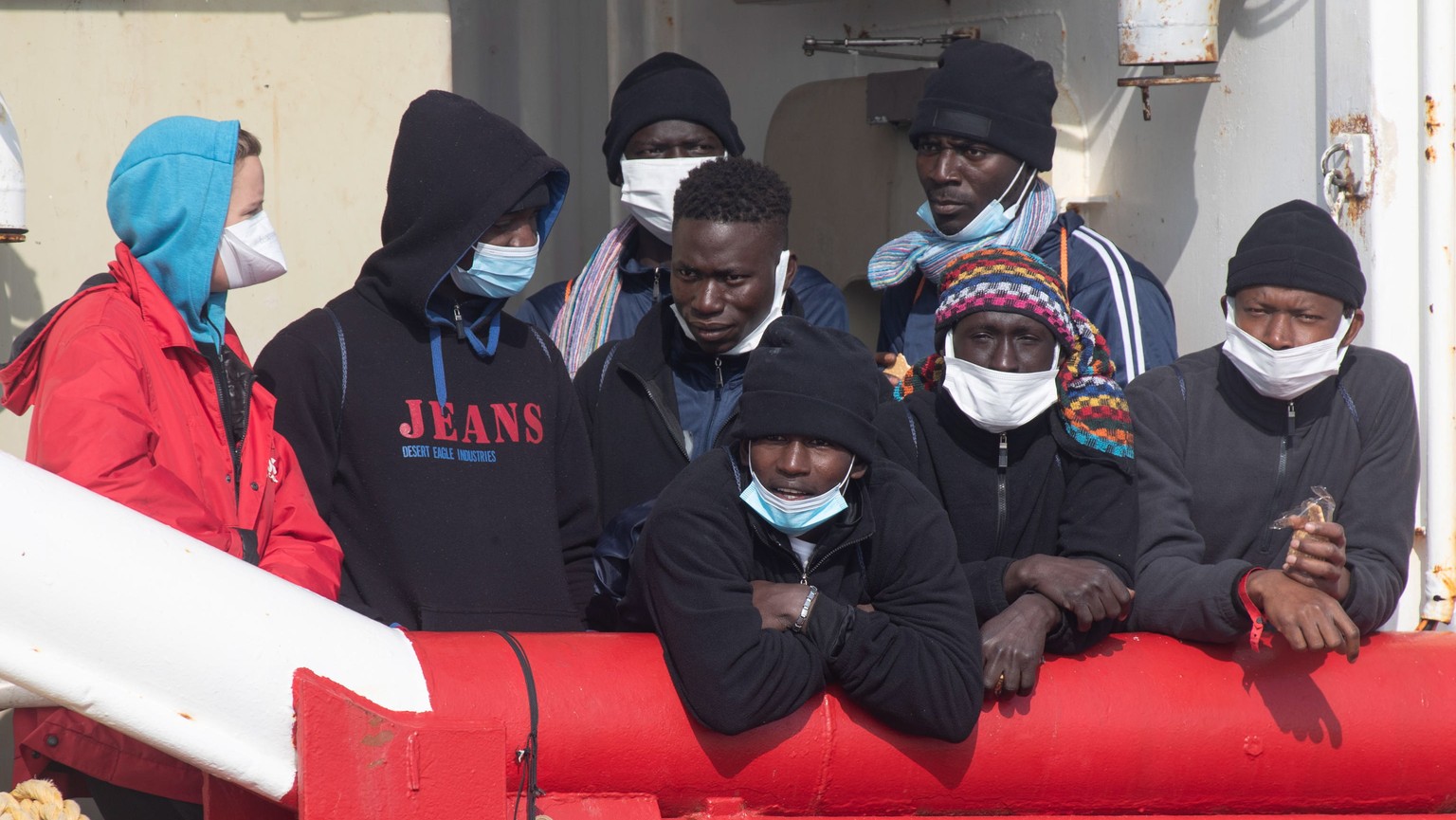 epa10474771 A group of migrants waits to disembark the rescue ship &#039;Ocean Viking&#039; of the NGO &#039;SOS Mediterranee&#039; after it arrived and moored at the port of Ravenna, Italy, 18 Februa ...