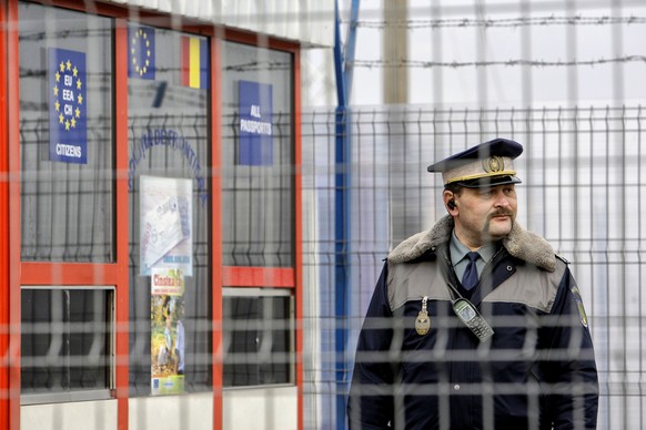 FILE - A Romanian border police officer stands guard at the railway border crossing between Romania and Moldova in Ungheni, Romania, on January 18, 2011.  Bulgaria and Romania have been given permission...
