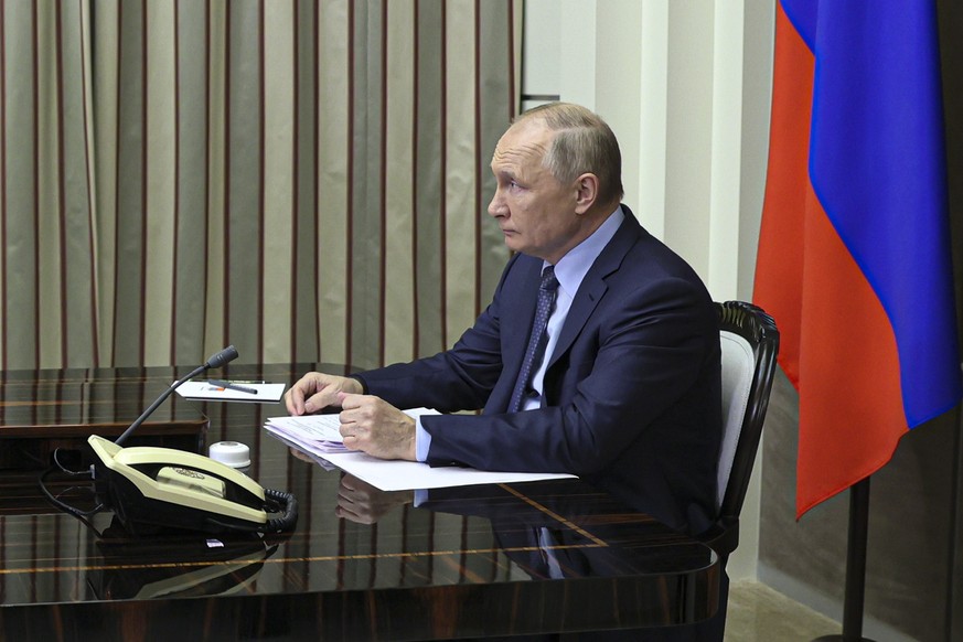 Russian President Vladimir Putin attends a video call with U.S. President Joe Biden at his Bocharov Ruchei residence in the Black Sea resort of Sochi, Russia, Tuesday, Dec. 7, 2021. The call was expec ...