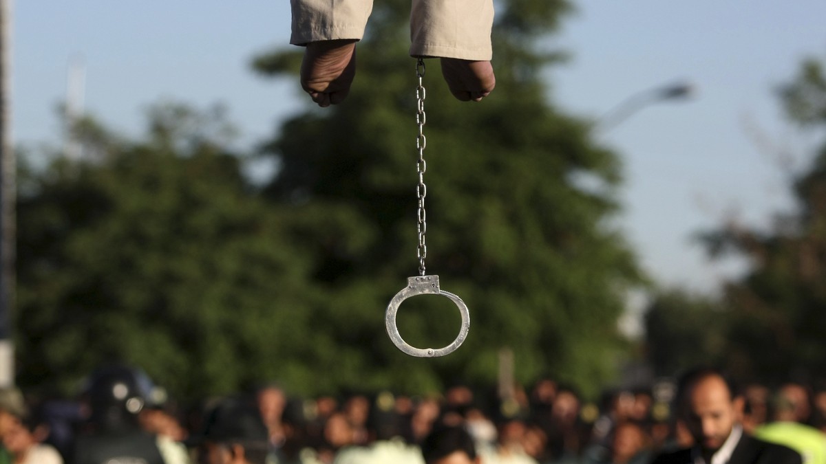 FILE - In this May 26, 2011 file photo, the feet of convicted man Mahdi Faraji, is seen with shackle, while he is being hanged, at the city of Qazvin about 80 miles (130 kilometers) west of the capita ...