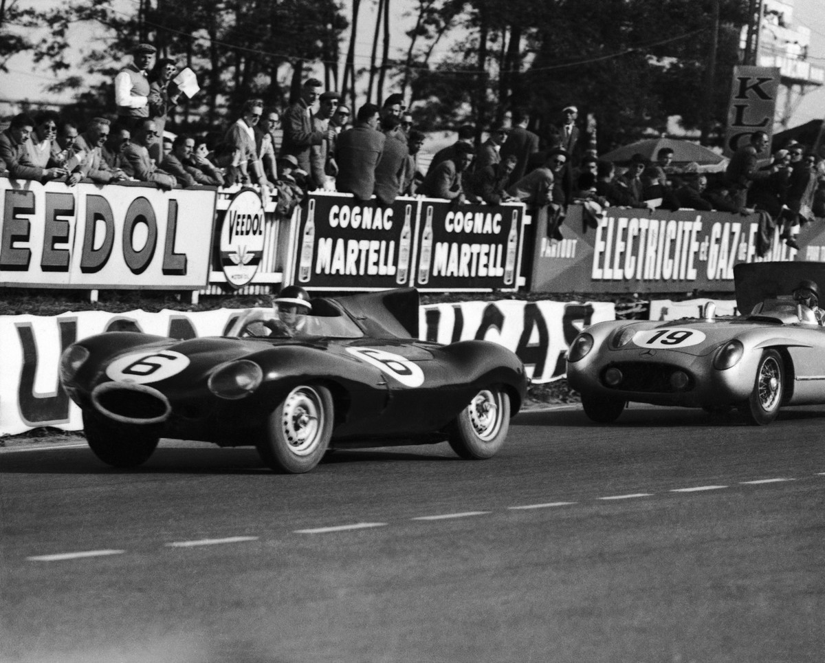 Britain's Mike Hawthorn driving his Jaguar car, drives past the stands, followed by Juan Fangio of Argentina, during the Le Mans 24-hour race on June 11, 1955. Hawthorn and his co-driver Ivor Bue ...