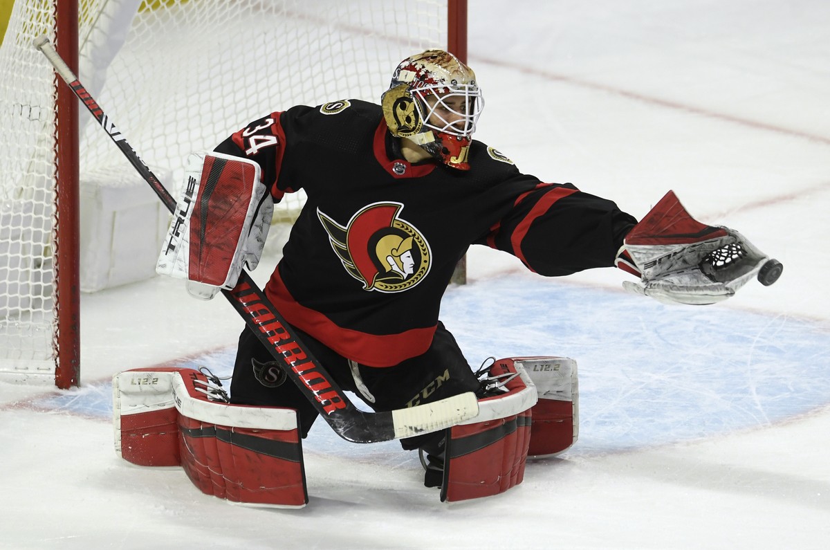 The puck comes out of the glove of Ottawa Senators goaltender Joey Daccord during the first period of the team's NHL hockey game against the Vancouver Canucks on Wednesday, March 17, 2021, in Ott ...