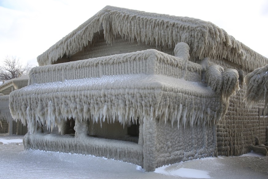 Houses along Hoover Beach is covered by ice from high winds and from the waves from Lake Erie, Saturday, Feb. 29, 2020, in Hamburg N.Y. Blowing snow has fallen around the state since Thursday, though  ...