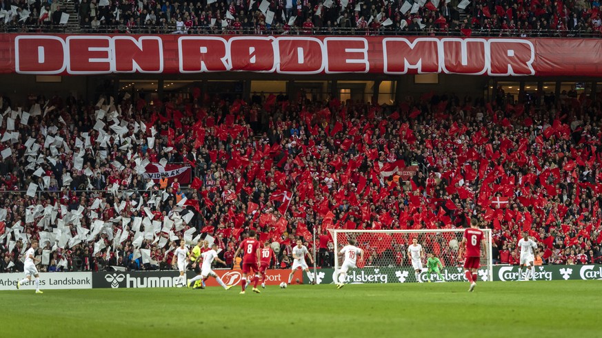 Danish supporteers wave white and red flags during the UEFA Euro 2020 qualifying Group D soccer match between Denmark and Switzerland at the Telia Parken stadium in Kopenhagen, Denmark, on Saturday, O ...