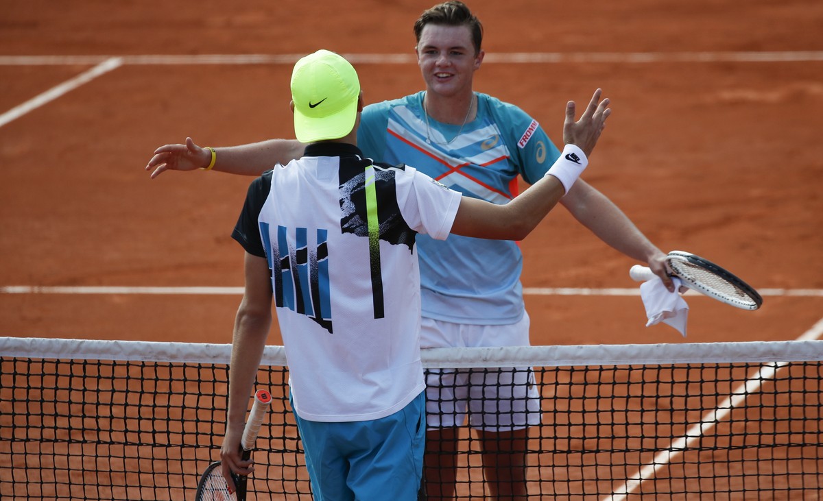 Switzerland's Dominic Stephan Stricker, right, is congratulated by Switzerland's Leandro Riedi after Stricker won the junior men's final match of the French Open tennis tournament at th ...