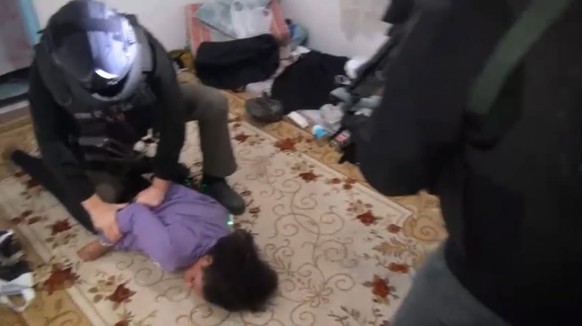 epa10305024 A photo taken on a video by the Istanbul Police shows police arresting a woman suspected of the previous day's deadly explosion in central Istanbul...