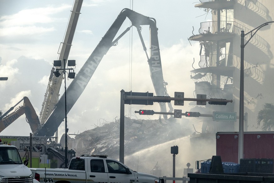 epa09302906 Miami-Dade Rescue team is searching in the partial collapsed 12-story condominium building in Surfside, Florida, USA, 26 June 2021. Miami-Dade Fire Rescue officials said more than 80 units ...