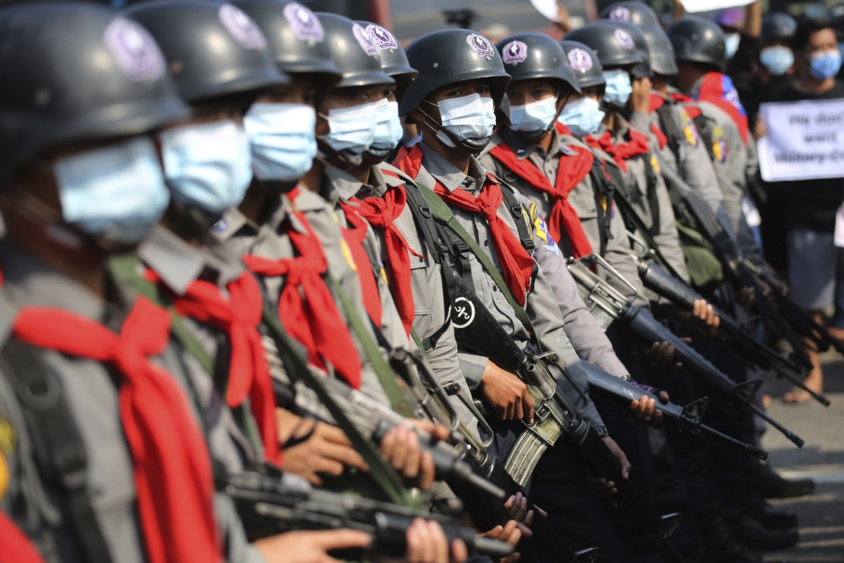 Armed riot police are seen near protesters in Naypyitaw, Myanmar on Monday, Feb. 8, 2021. Tension in the confrontations between the authorities and demonstrators against last week's coup in Myanm ...