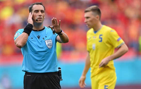 epa09279780 Argentinian referee Fernando Andres Rapallini checks with the VAR during the UEFA EURO 2020 group C preliminary round soccer match between Ukraine and North Macedonia in Bucharest, Romania ...