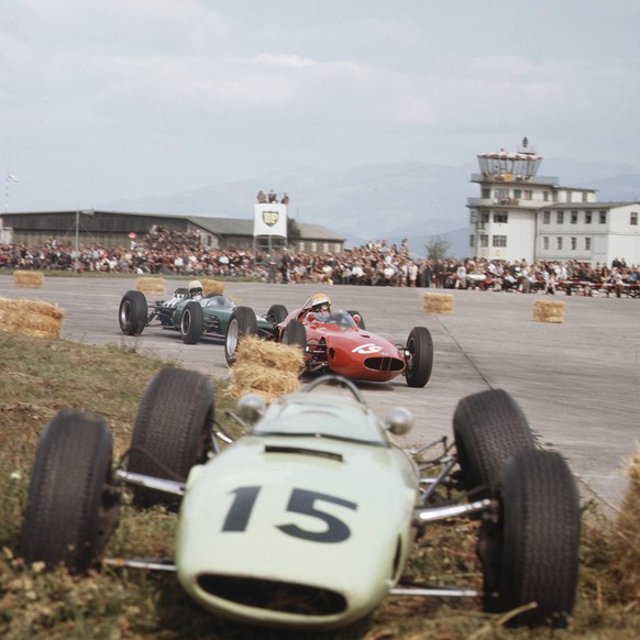 1964 Austrian Grand Prix. Zeltweg, Austria. 21-23 August 1964. Tony Maggs (BRM P57) and Bob Anderson (Brabham BT11-Climax) pass the crashed BRP 1 BRM of Trevor Taylor. They finished in 4th and 3rd pos ...