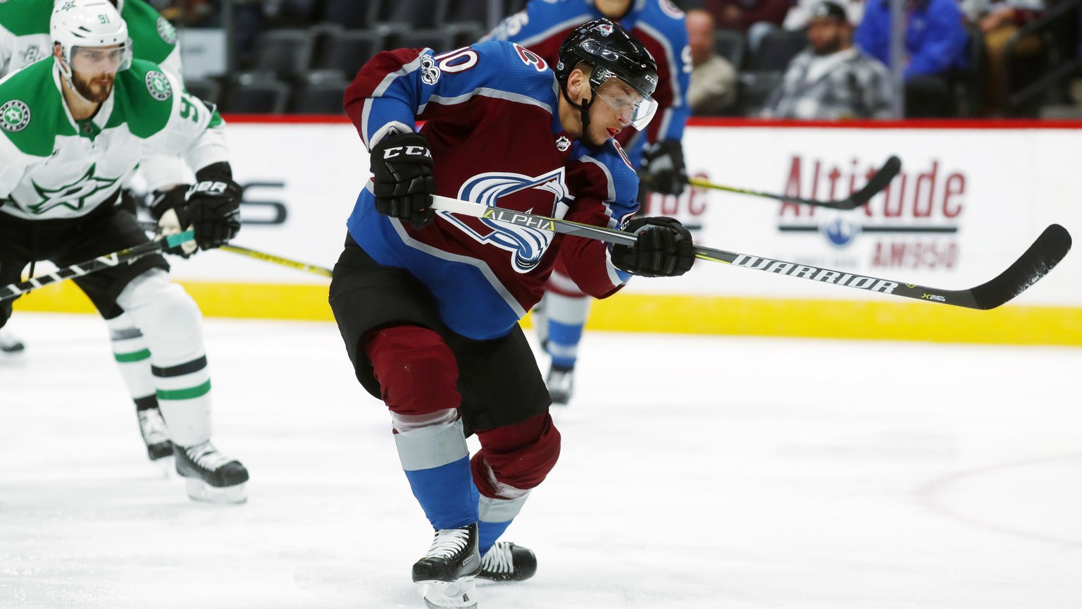 Colorado Avalanche right wing Sven Andrighetto, front, of Switzerland, takes a shot on the net as Dallas Stars center Tyler Seguin defends in the first period of an NHL hockey game Tuesday, Oct. 24, 2 ...