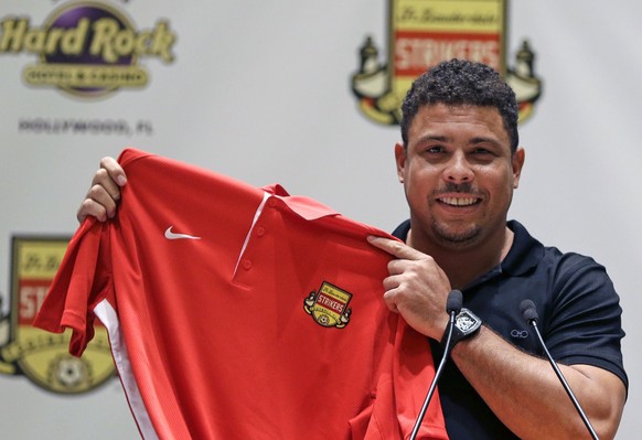 Three-time FIFA player of the year Ronaldo Luís Nazário de Lima poses for photographers with a Fort Lauderdale Strikers jersey after talking about his new role as part owner of the Fort Lauderdale Str ...