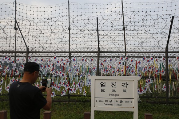 epaselect epa06180730 A visitor takes a pictures as he visit near the freedom bridge symbolizing the division of Korea into North and South on Imjingak near the Demilitarized Zone (DMZ) in Paju, Gyeon ...