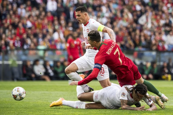 Switzerland&#039;s midfielder Granit Xhaka, Portugal&#039;s forward Cristiano Ronaldo and Switzerland&#039;s defender Kevin Mbabu, from left, in action during the UEFA Nations League semi-final soccer ...