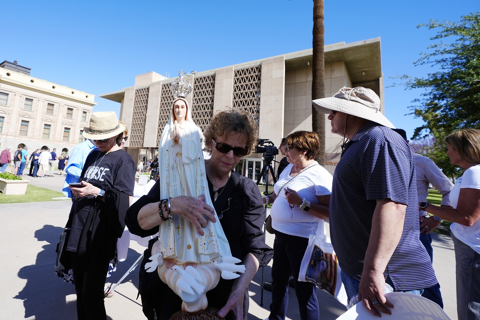 Pro-life demonstrators walk in the front of the Arizona Capitol prior to the vote on the proposed repeal of Arizona&#039;s near-total ban on abortions prior to winning approval from the state House We ...