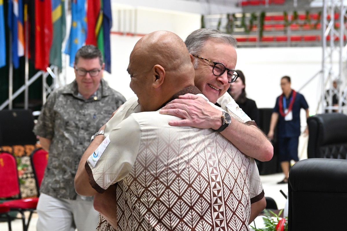 epa11567930 Australian Prime Minister Anthony Albanese receives a hug from Prime Minister of Tuvalu Feleti Teo (front) at the start of the plenary session at the 53rd Pacific Islands Forum Leaders Mee ...